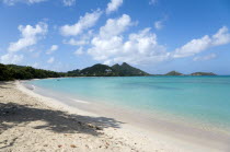 Waves breaking on Paradise Beach at LEsterre Bay with the turqoise sea and Point Cistern and The Sister Rocks beyond.Beaches Caribbean Destination Destinations Grenadian Greneda Resort Sand Sandy Sce...