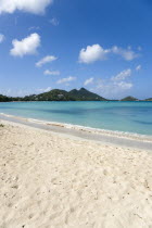 Waves breaking on Paradise Beach at LEsterre Bay with the turqoise sea and The Sister Rocks beyond.Beaches Caribbean Destination Destinations Grenadian Greneda Resort Sand Sandy Scenic Seaside Shore...