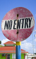 Colourful and weather worn No Entry road sign in Clifton.Caribbean West Indies Windward Islands Colorful Destination Destinations Ecology Entorno Environmental Environnement Green Issues Signs Displa...