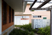 Derelict bakery set amongst waste ground in Clifton.Caribbean West Indies Windward Islands Ecology Entorno Environmental Environnement Green Issues