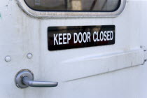 Sign on a door of an inter island ferry ship that reads Keep Door Closed.Caribbean Destination Destinations Grenadian Greneda West Indies Grenada Windward Islands Signs Display Posted Signage