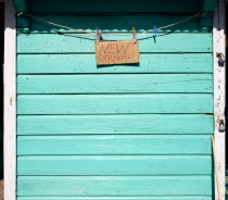 New Arrival sign on the padlocked turqoise shutter of a shop in Hillsborough.Caribbean Destination Destinations Grenadian Greneda West Indies Grenada Signs Display Posted Signage Store