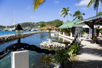 The capital of Clifton and the harbour seen from the terrace of the Anchorage Yacht Club restaurant and bar beside the shark pool.Caribbean West Indies Windward Islands Destination Destinations Inn P...