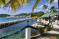 The capital of Clifton and the harbour seen from the terrace of the Anchorage Yacht Club restaurant and bar beside the shark pool.Caribbean West Indies Windward Islands Destination Destinations Inn P...