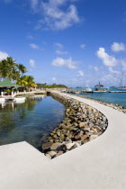 The walkway and shark pool beside the bar and restaurant of the Anchorage Yacht Club in Clifton Harbour.Caribbean West Indies Windward Islands Destination Destinations Inn Pub Scenic Tavern