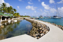 The walkway and shark pool beside the bar and restaurant of the Anchorage Yacht Club in Clifton Harbour.Caribbean West Indies Windward Islands Destination Destinations Inn Pub Scenic Tavern