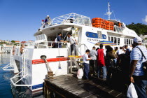 The Osprey Shuttle catamaran inter island service in the Carenage with passengers boarding in the morning for Carriacou and Petit Martinique.Caribbean Destination Destinations Grenadian Greneda West...