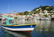 The Carenage in the capital with houses lining the hillside and a fishing boat moored in the harbour.Caribbean Destination Destinations Grenadian Greneda West Indies Grenada