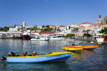 The Carenage in the capital with houses lining the hillside and colourful water taxis moored in the harbour.Caribbean Destination Destinations Grenadian Greneda West Indies Grenada Colorful