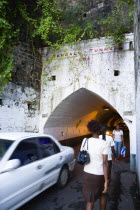 The Sendall Tunnel built in 1894 with pedestrians and cars moving through it.Caribbean Destination Destinations Grenadian Greneda West Indies Grenada Automobiles Autos Ecology Entorno Environmental E...