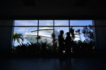 Tourists in the terminal building looking at the cruise ship liners Caribbean Princess and Aida Aura docked at the Cruise Ship Terminal in the capital St Georges.Caribbean Destination Destinations Gr...