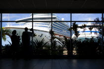 Tourists in the terminal building looking at the cruise ship liners Caribbean Princess and Aida Aura docked at the Cruise Ship Terminal in the capital St Georges.Caribbean Destination Destinations Gr...