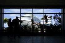 Tourists in the terminal building looking at the cruise ship liners Caribbean Princess and Aida Aura docked at the Cruise Ship Terminal in the capital St Georges.Caribbean Destination Destinations Gr...