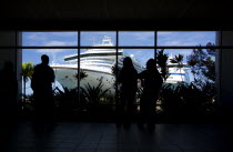Tourists in the terminal building looking at the cruise ship liners Caribbean Princess and Aida Aura docked at the Cruise Ship Terminal in the capital St Georges.Caribbean Destination Destinations Gr...