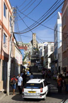 St Juille Street with overhead poer cables busy with traffic and pedestrian shoppers leading to the hurricane damaged and roofless Roman Catholic Cathedral in the capital.Caribbean Destination Destin...