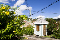 Colourful sentry post set amongst flowering plants on the road up from the capital to Fort George overlooking the capital.Caribbean Destination Destinations Grenadian Greneda West Indies Grenada Colo...