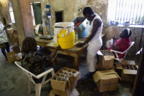 Female workers hand bottling the rum at the River Antoine distillery.Caribbean Destination Destinations Grenadian Greneda West Indies Grenada