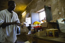 Male worker hand labelling the bottles at the River Antoine rum distillery.Caribbean Destination Destinations Grenadian Greneda West Indies Grenada One individual Solo Lone Solitary