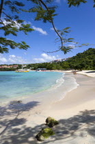 Gentle waves on BBC Beach in Morne Rouge Bay with tourists in the sea on the beach and aboard their tour catamaran in the aquamarine water.Caribbean Destination Destinations Grenadian Greneda West In...