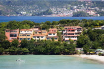 BBC Beach in Morne Rouge Bay lined with holiday apartment villas and the capital of St Georges in the distance.Caribbean Destination Destinations Grenadian Greneda West Indies Grenada Flat Sand Sandy...