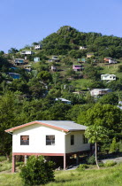 Houses built on stilts lining a hillside.Caribbean Destination Destinations Grenadian Greneda West Indies Grenada Ecology Entorno Environmental Environnement Green Issues Scenic