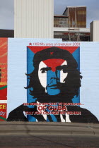 West  Falls Road  Political murals painted on walls of the Lower Falls Road area showing Ernesto Che Guevara with an anti US blockade message.PoliticalNorthernBeal FeirsteUrbanArchitectureSocial...