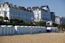 Beach huts below the seafront promenade and Hotels.European Great Britain Northern Europe UK United Kingdom British Isles Beaches Holidaymakers Resort Sand Sandy Seaside Shore Sunbather Tourism Touri...