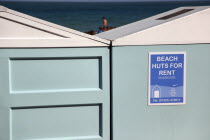 Beach huts below the seafront promenade and Hotels.European Great Britain Northern Europe UK United Kingdom British Isles Beaches Holidaymakers Resort Sand Sandy Seaside Shore Sunbather Tourism Touri...