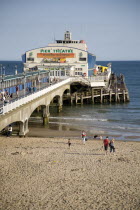 Sandy Beach and Pier with tourists sunbathing.Blue Destination Destinations European Great Britain Holidaymakers Immature Kids Northern Europe Sand Sandy Beaches Tourism Seaside Shore Tourist Tourist...