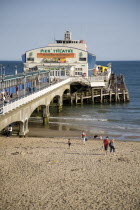 Sandy Beach and Pier with tourists sunbathing.Blue Destination Destinations European Great Britain Holidaymakers Immature Kids Northern Europe Sand Sandy Beaches Tourism Seaside Shore Tourist Tourist...