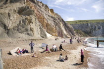 Coloured Sands  Needle Park. People sunbathing on the beach.Blue Colored Destination Destinations European Great Britain Holidaymakers Immature Kids Northern Europe Sand Sandy Beaches Tourism Seaside...