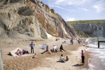 Coloured Sands  Needle Park. People sunbathing on the beach.Blue Colored Destination Destinations European Great Britain Holidaymakers Immature Kids Northern Europe Sand Sandy Beaches Tourism Seaside...