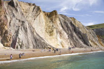 Coloured Sands  Needle Park. People sunbathing on the beach.Blue Colored Destination Destinations European Great Britain Holidaymakers Immature Kids Northern Europe Sand Sandy Beaches Tourism Seaside...