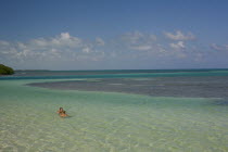 Two women are swimming at an exotic crystal clear green blue sea on a bright sunny day with blue sky and white clouds.SummerHolidaysVacationRelaxSunTropicalTourismSailYachtRelaxBeachIdeal...