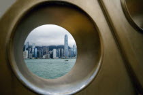 VICTORIA HARBOUR. skyline shoot through a hole  part of a bronze sculpture at Kowloons side road called Avenue of Stars  shoot on a cloudy day.FuturisticArchitectureFutureModernCultureDesignCon...