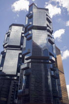 Queensway. Lippo Centre skyscraper shoot on a bright day with blue sky and white clouds.UrbanLandscapeContemporaryTourismHolidaysSummerDesignVacationSkylineSkyscraperVerticalInnovativeHei...