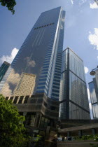 Reflection of a skyscraper on the glass of another skyscraper shoot on a bright sunny day with blue sky and white clouds.UrbanLandscapeContemporaryTourismHolidaysSummerDesignVacationSkylineS...