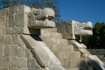 Sculptures representing Crocodile heads on an ancient structure at Chichen Itza archeological site.MayaMayanToltecHistorySunVacationHolidaysTravelArcheologyHistoricalReligionBuildingStruc...