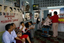 Traditional barber shop with old decorations and customers waiting to be served. TraditionOld fashionCultureFolkloreDecorationHotHeatSummerHolidaysVacationLifestyleCosmeticsExoticPremise...