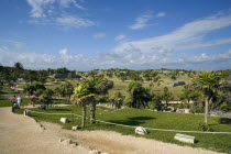 General Aspect of Tulum archeological site on a bright sunny day wirth blue sky and white clouds.MayanToltecHistorySunVacationHolidaysTravelArcheologyHistoricalReligionBuildingStructureAr...