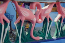 Mexican child seen through Pink Flamingo sculptured fence.American Children Hispanic Kids Latin America Latino One individual Solo Lone Solitary