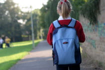 Girl walking to school with her rucksack full of books.UKEnglandUnitedKingdomGreat BritainEuropeEuropeanEducationLearningGirlFemaleChildStudentBagSatchel British Isles Children Immature...