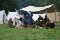 At the Saxon encampment of the reenactment of the 1066 Battle of Hastings.Norman Anglo Saxon fire medieval reenactment Battle of Hastings 11th century eleventh women eating cooking life living histor...