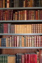 Old books on a book case inside Warwick Castle.old  books  case  bookcase  book  antique  shelves  UK  heritage  history  historic  historical  knowledge  Warwick castle  novels  leather  bound  Engl...