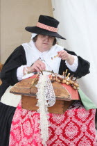 A 17th century English woman making lace  at the reenactment of the battle of Faringdon in the English Civil war.17th century  English  woman  making lace  female  UK  history  historic  England  Bri...