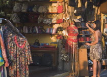 Rhodes Town.  Young female tourist shopping on Odos Sokratous the main shopping street of bazaar or old Ottoman area in late golden afternoon sun.   UNESCO World Heritage Site.  Greek islandsDodecan...