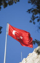 Turkish flag flying from wall of Bodrum castle  formerly Castle of St Peter under Knights Hospitaller of Rhodes  Ottoman since 1522.Turkish Aegean coastmediterraneanresortformerly HalicarnassusHa...