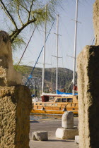 Gulet moored in Bodrum harbour viewed from castle wallsTurkish Aegean coastmediterraneanresortformerly HalicarnassusHalikarnasregion of CariaDorian Greek occupiedsunsunshineSummerseasonJun...