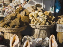 Baskets of sponges and sea shells on sale in bazaar area. Turkish Aegean coastmediterraneanresortformerly HalicarnassusHalikarnasregion of CariaDorian Greek occupiedsunsunshineSummerseason...