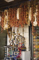 Display of Nargile or water pipes and strings of dried chillies  garlic and other spices for sale outside shop.Fethiyeformerly Telmessosformerly modern Greek MakriAegeanTurkish rivieraSummersea...